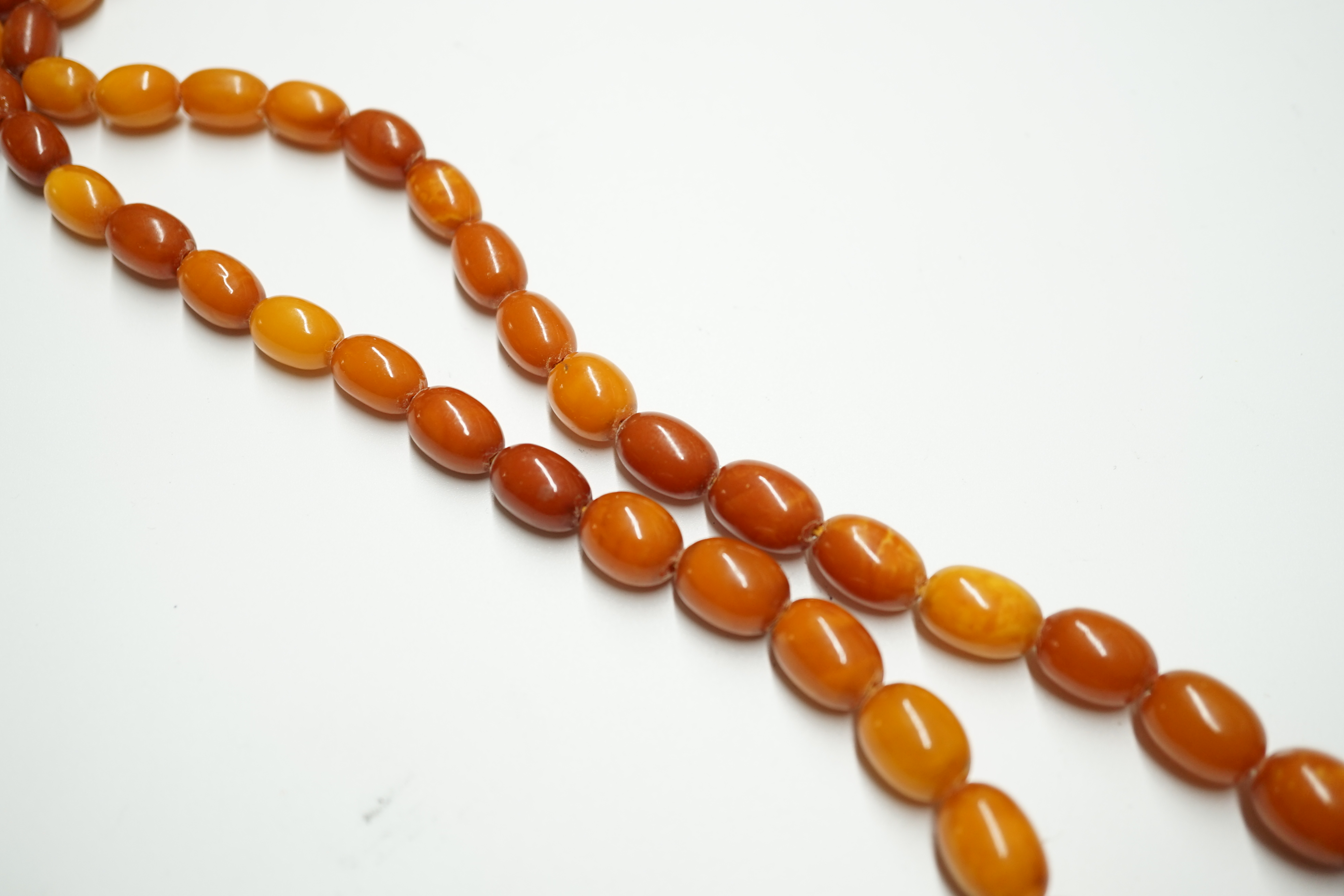 A single strand graduated oval amber bead necklace, 62cm, gross weight 33 grams